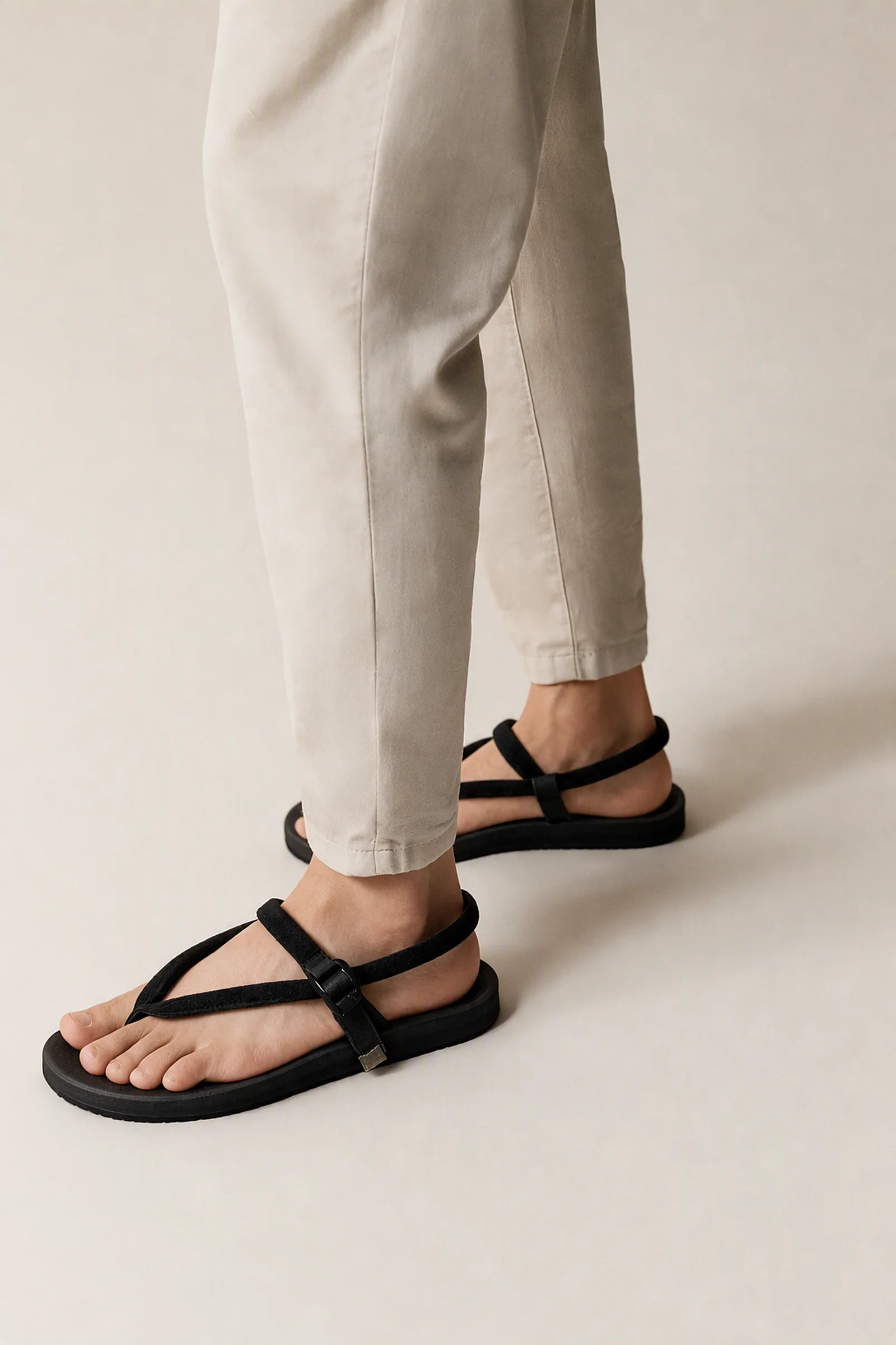 Kasual x Gahalu Wakatobi sandals on foot, seen from the knee down.